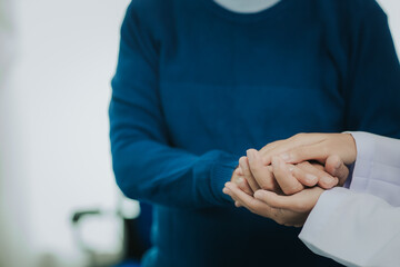 Female doctor talking taking care of her senior patient give support Doctor helping elderly patient with Alzheimer's disease A female attendant holds the hand of an elderly man