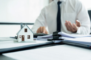 Businesswoman embraces client after successful property negotiation.