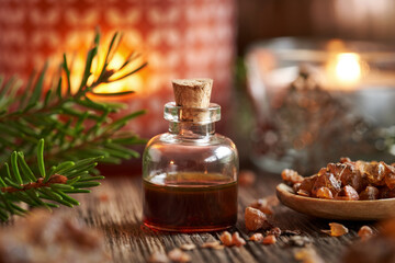 Obraz na płótnie Canvas Christmas essential oil with myrrh resin and a candle
