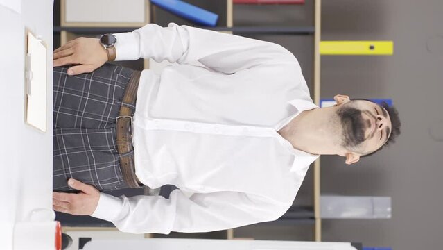 Vertical video of Businessman doing exercises to be done in the office.