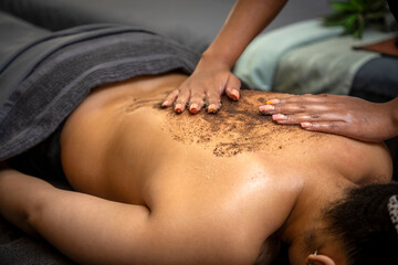 African Style Day Spa  with a African lady Having a Massage with a scrub.