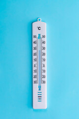thermometer hanging on a blue background