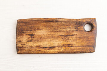 Empty rectangular wooden cutting board on white wooden. Top view