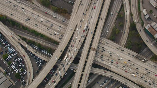 Famous Freeway interchange in Downtown Los Angeles, California. United States.Overhead Dolly out Aerial View of Traffic in Interstate 110 and 10 Highway Full of Cars and Trucks.  Transportation.