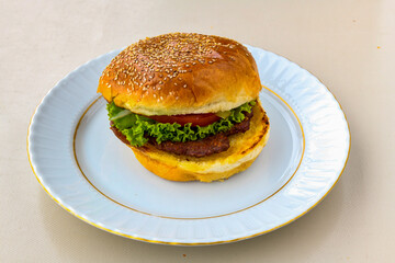 Big tasty burger with beef cutlet on a plate. Hamburger. Crispy chicken burger.