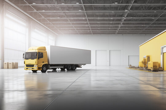 A yellow truck parked in an empty warehouse.