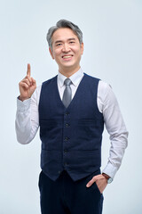 A middle-aged man in a suit is doing various facial expressions and hand movements.