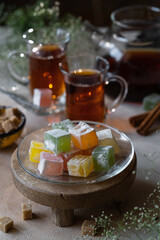 Rahat lukum, oriental sweets on a glass plate, near tea in oriental style, close-up 