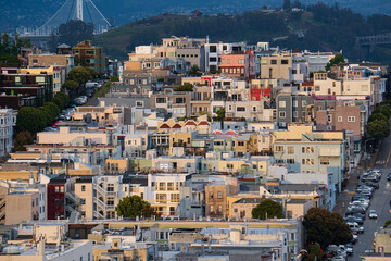 Colorful houses of San Francisco crawling up the hill after a rain storm in spring, USA. Dark...