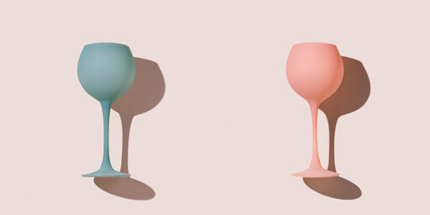 Minimal composition from two pink blue colored wine glasses on pastel pink background, stylish layout of goblets, stemmed glass. Entertainment, event, party concept. Abstract alcohol drinks