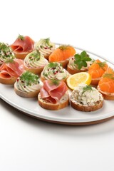 Assorted canapés brightly illuminated under kitchen lights isolated on a white background 