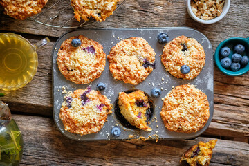 Carrot muffin with blueberries and walnuts.  Wooden background. Top view. 