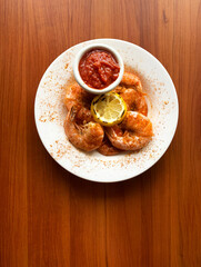 Steamed Shrimp with Sauce on Wood Background