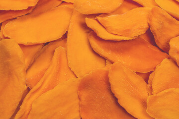 Dry tasty mango slices isolated on a white background.