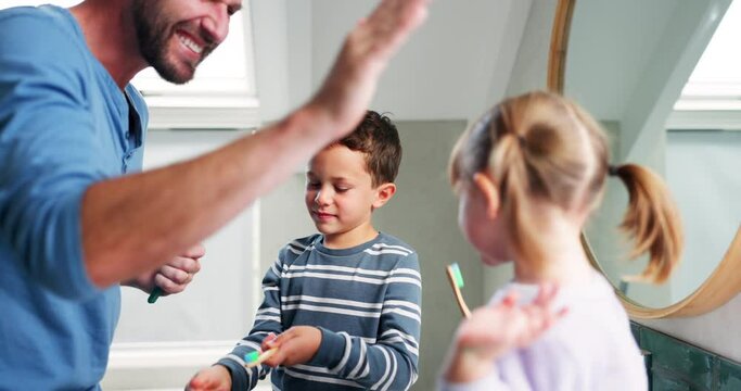 High five, bathroom and a father and children brushing teeth at home and celebrate development and health. Happy man and kids in family house for dental hygiene, happiness or motivation in morning