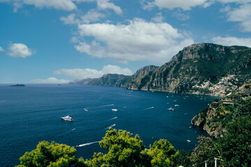 Amalfi Sea Coast with Umbrellas, people swim, and Yachts. Clean and blue sea where to swim. Photo...