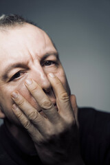 Man 50s closeup face stress feelings emotions