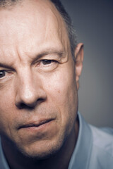 Studio shot portrait man 50s pensive expression