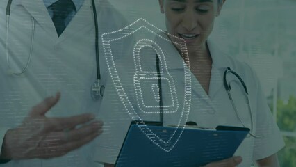 Animation of dots forming padlock in shield over caucasian doctors discussing patient reports - Powered by Adobe