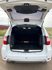 Modern sedan car have an open trunk. The car boot is open and ready for luggage loading. Empty space at the boot of the sedan car. Rental car service