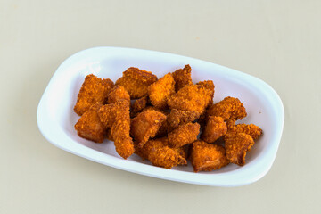 Fried Chicken breast hot crispy strips crunchy chicken tenders  isolated on white background.Nuggets isolated on white background on a plate