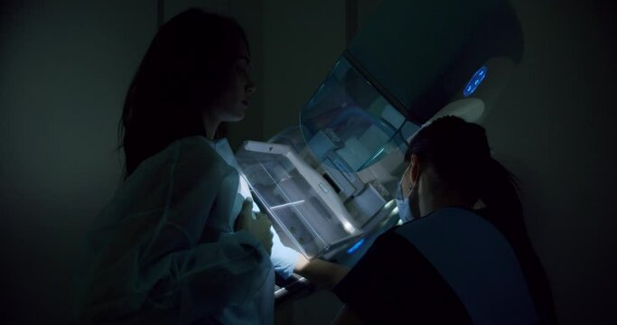 Woman patient doing mammography screening in hospital radiology room. Female examination breast with modern medical equipment. Health diagnostic concept. Oncology prevention