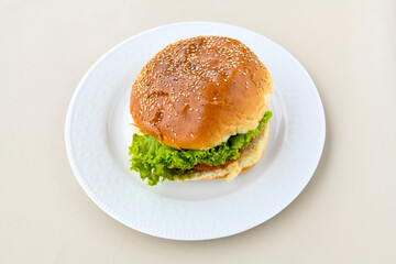 Big tasty burger with beef cutlet on a plate. Hamburger. Crispy chicken burger.