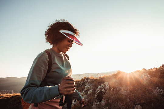Young woman hiking in nature during sunset