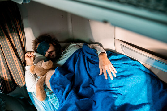 Young man sleeping in truck cabin