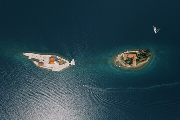 Island of Gospa od Skrpjela near the island of St. George in the sea. Montenegro. Top view - obrazy, fototapety, plakaty