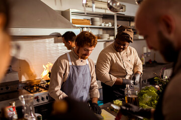 Young male chefs working in the kitchen