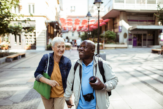 Senior couple walking in the city on vacation