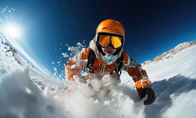 Fotobehang A snowboarder in vibrant orange gear carves through fresh snow with dynamic speed against a clear blue sky on a bright winter day. © apratim