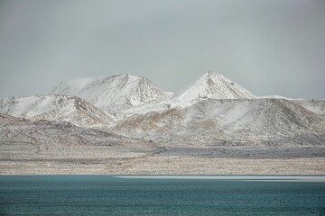 Stunning landscape in the Ali region of Tibet, with majestic mountains and a tranquil blue lake