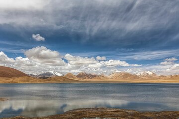Stunning landscape in the Ali region of Tibet, with majestic mountains and a tranquil blue lake