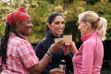 Happy mature women having fun and coffee outdoors.