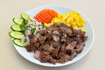 Turkish and Arabic Traditional Ramadan doner kebab with tasty tomato sauce and rice or turkish pilav in white plate on wood table background. ( Pilav ustu et doner, Hatay tavuk doner iskender kebap )