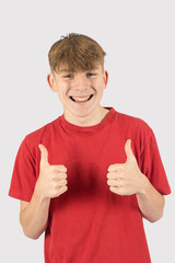 Headshot of a teenage boy giving thumbs up