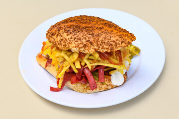 Close-up shot of Izmir's famous Turkish Traditional Kumru Sandwich, Çeşme Kumru , ingredients ready to eat salami, sucuk , tomato, cheddar cheese and fried cheese. Yengen eritme karisik sandvic.