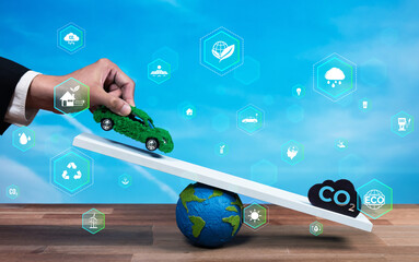Businessman balance green EV car model scale with CO2 emission icon, demonstrate concept of ESG...