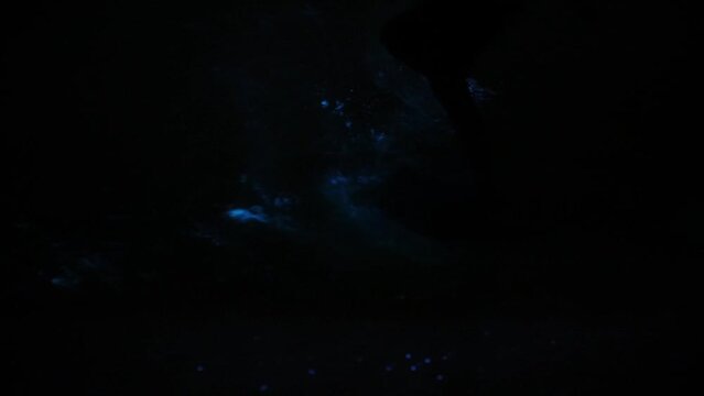 bioluminescent water being splashed 