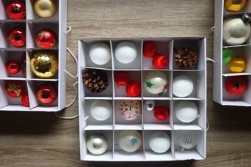 Boxes with various organized Christmas ornaments. Decorating or taking down the Christmas tree. Top...