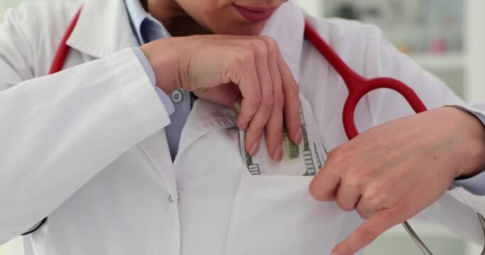 Therapist puts money dollar in his pocket in clinic