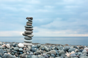 Pebble tower on the beach. Relaxing peaceful spa tranquility concept with copy space for text