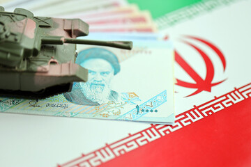 Iranian army toy tank drive on iranian bills of rial currency on flag of Islamic Republic of Iran...