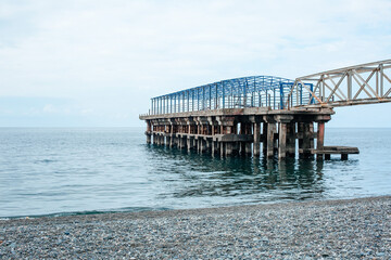 Fototapeta premium Pier on the sea in Georgia on a cloudy summer day