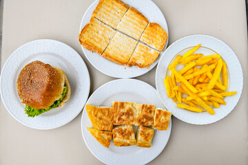 Table scene of assorted take out or delivery foods. Traditional Turkish cuisine. Various Turkish meal and appetizers. Top down view on a table.