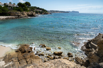 rocky beach and blue sea water on the Mediterranean coast scenic seascape for travel and holidays