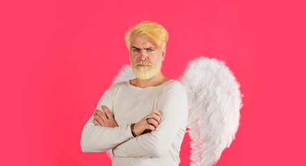 Happy Valentines Day. Male angel in white wings with crossed arms. Bearded man with blonde hair in...