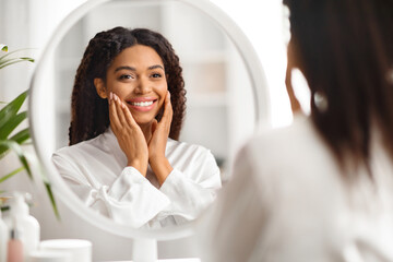 Natural Beauty. Attractive African American Woman Smiling To Her Reflection In Mirror